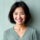 Portrait of Sarah Chen, 48, vibrant and healthy, smiling genuinely.