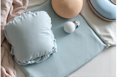 Various recovery sleep aids arranged aesthetically: a cooling mattress pad, a soft weighted blanket, and natural sleep aroma diffuser.